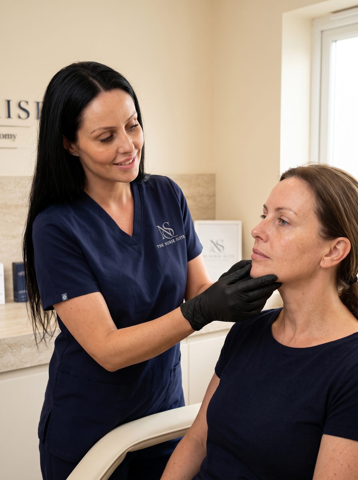 Danielle assessing a client's face during a medical aesthetics consultation