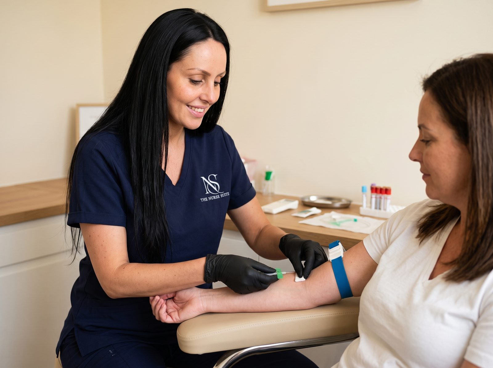 Danielle taking a blood sample from a client's arm